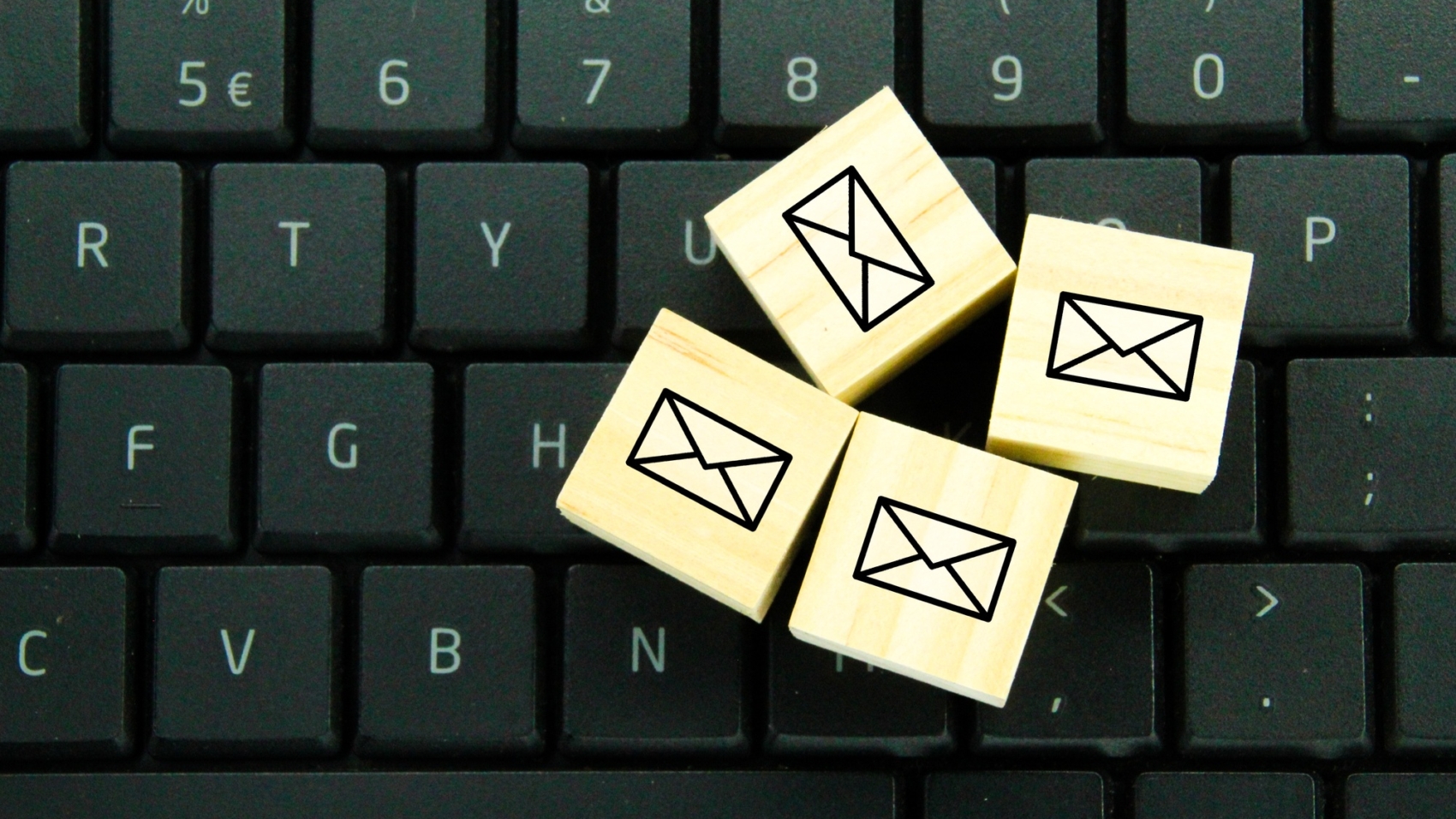 wooden cube with email icon.