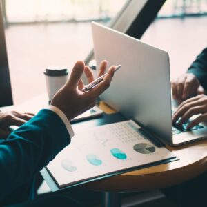 Two businessmen are talking about the results of operations in the company financial statements